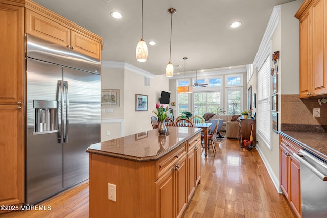 11 Aspen Ln, Tinton Falls, NJ 07724 - kitchen with appliances with stainless steel finishes, crown molding, recessed lighting, dark stone countertops, and a kitchen island