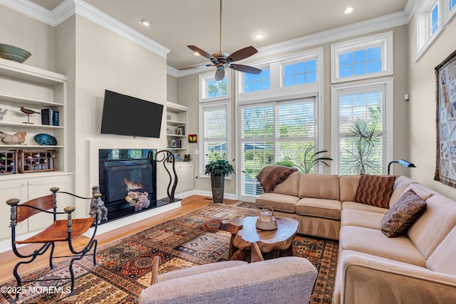 11 Aspen Ln, Tinton Falls, NJ 07724 - living room featuring ornamental molding, ceiling fan, a warm lit fireplace, built in features, and recessed lighting