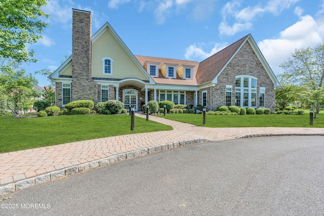 11 Aspen Ln, Tinton Falls, NJ 07724 - view of front of house featuring stone siding, a front yard, and a chimney