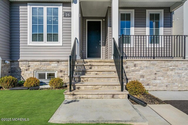 25 Blue River Way, Lakewood, NJ 08701 - entrance to property with stone siding, a porch, and a lawn
