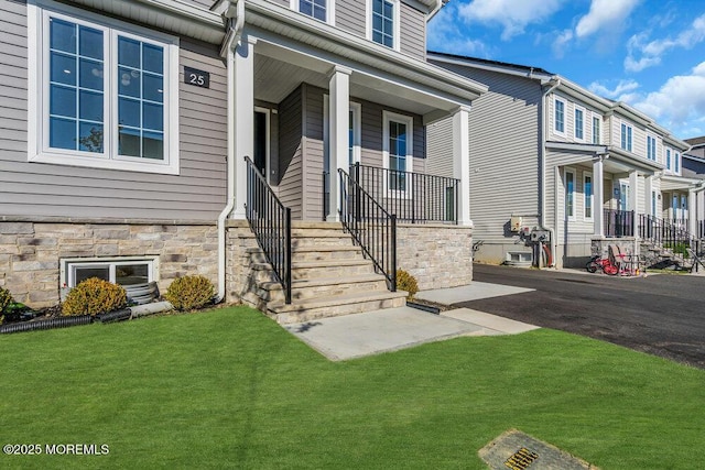 25 Blue River Way, Lakewood, NJ 08701 - view of exterior entry with a porch and a lawn