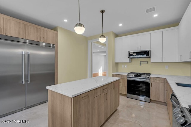 25 Blue River Way, Lakewood, NJ 08701 - kitchen with stainless steel appliances, light marble finish flooring, light stone countertops, a kitchen island, and recessed lighting