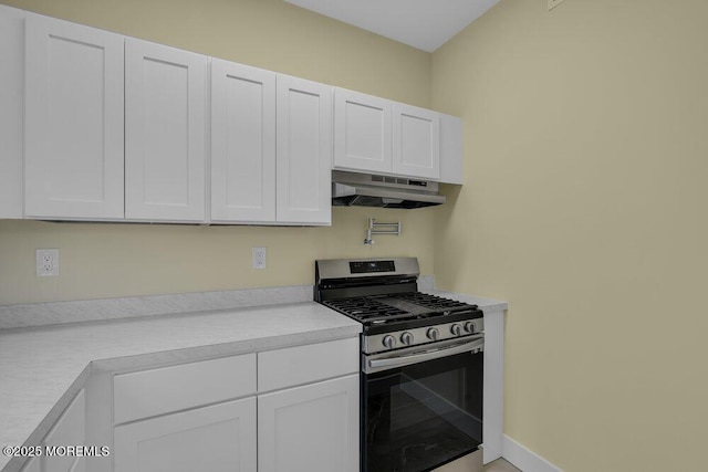 25 Blue River Way, Lakewood, NJ 08701 - kitchen with stainless steel gas stove, under cabinet range hood, white cabinets, and light countertops