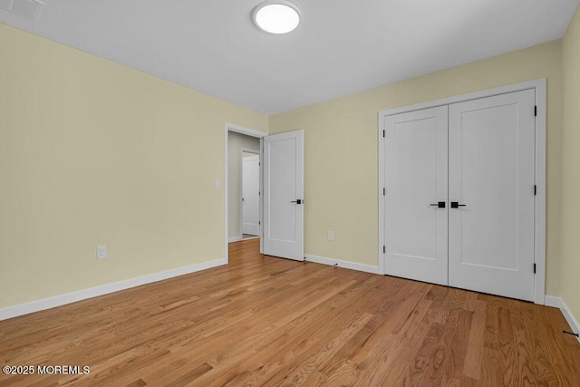 25 Blue River Way, Lakewood, NJ 08701 - unfurnished bedroom featuring baseboards, light wood-type flooring, and a closet