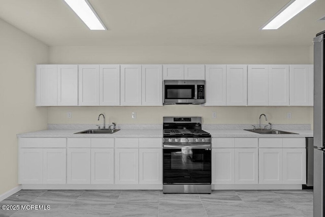 25 Blue River Way, Lakewood, NJ 08701 - kitchen with stainless steel appliances, a sink, white cabinets, and light countertops