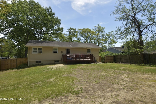 rear view of property featuring a wooden deck