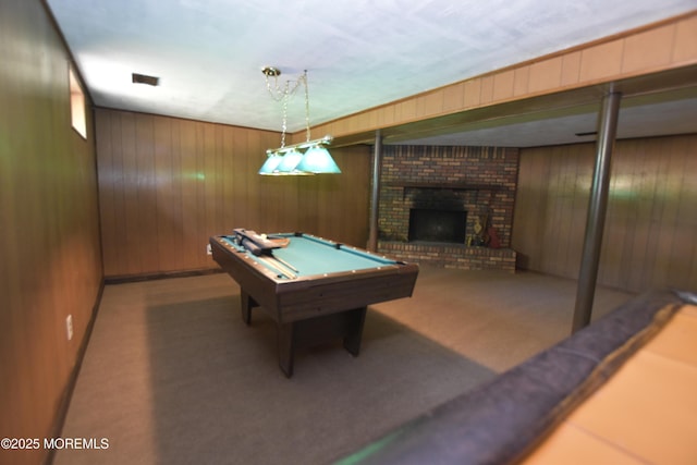 game room with a fireplace, billiards table, wooden walls, and carpet