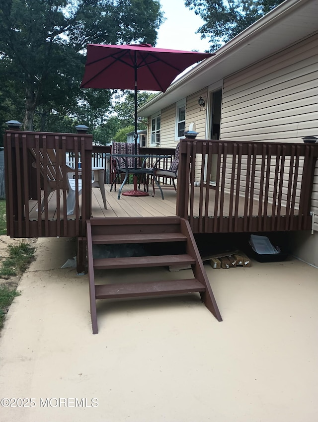wooden terrace featuring outdoor dining area