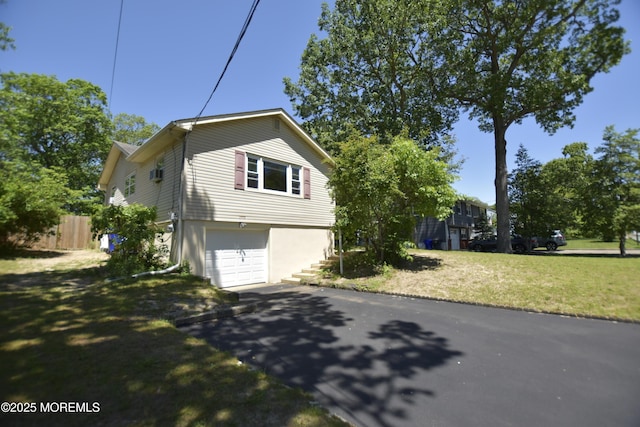 1595 Forge Pond Rd, Brick, NJ 08724 - view of side of property featuring driveway, a garage, and stucco siding