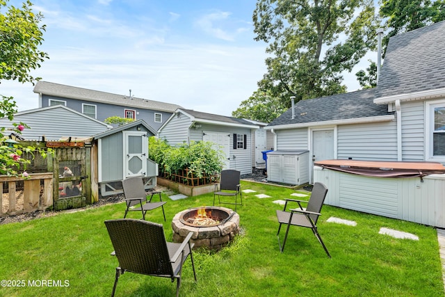129 Foster Rd, Toms River, NJ 08753 - view of yard featuring a hot tub, an outdoor fire pit, an outdoor structure, and a storage shed