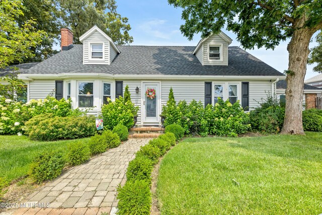 129 Foster Rd, Toms River, NJ 08753 - cape cod-style house featuring a front lawn, a chimney, and a shingled roof