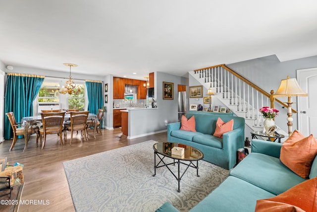 129 Foster Rd, Toms River, NJ 08753 - living area featuring a chandelier, stairway, wood finished floors, and baseboards