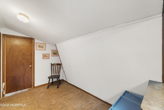 bonus room with vaulted ceiling, light floors, and baseboards
