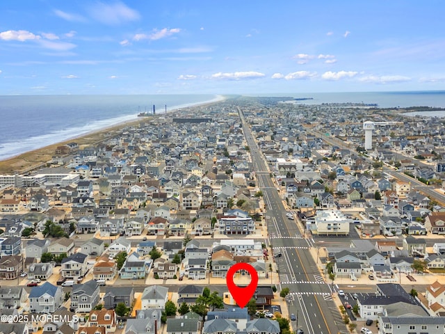 aerial overview of property's location with extended coastline and nearby suburban area