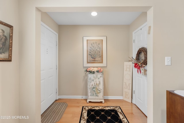 foyer entrance with light wood-type flooring, baseboards, and recessed lighting