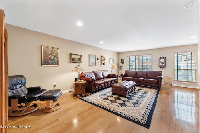 living area featuring hardwood / wood-style floors, baseboards, and recessed lighting