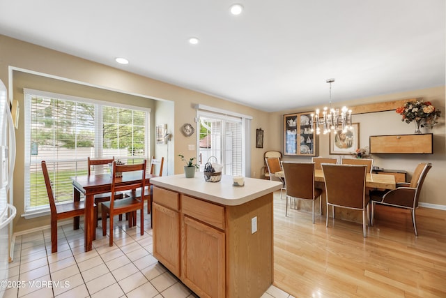 kitchen with light countertops, a chandelier, a center island, recessed lighting, and hanging light fixtures