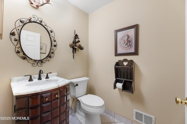 half bathroom with tile patterned flooring, toilet, vanity, and baseboards
