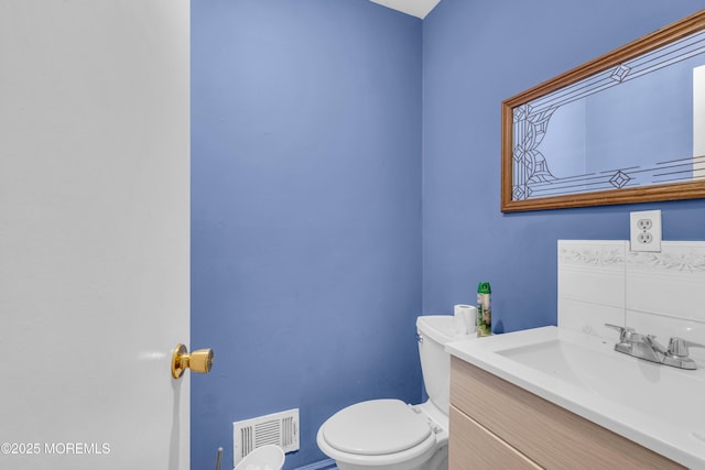 11 Factory St, Freehold, NJ 07728 - half bathroom featuring toilet, vanity, and baseboards