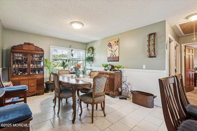 19 Acapulco Dr, Brick, NJ 08723 - dining area featuring a textured ceiling, a wainscoted wall, attic access, and light tile patterned floors