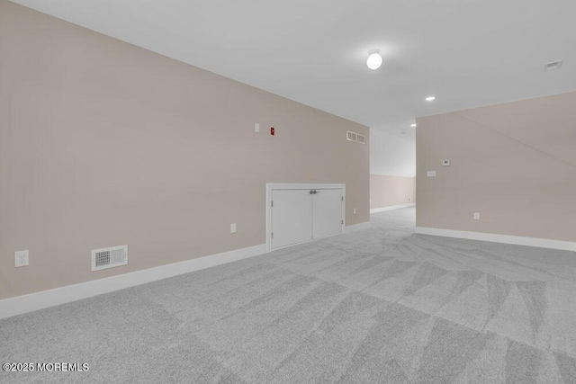spare room featuring carpet floors, baseboards, and recessed lighting