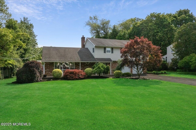 19 Meadowbrook Ln, Freehold, NJ 07728 - traditional-style home with driveway, a front lawn, an attached garage, and a chimney