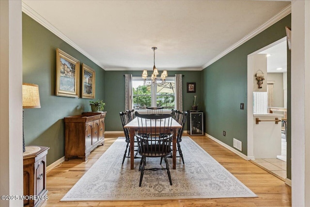 19 Meadowbrook Ln, Freehold, NJ 07728 - dining space with a chandelier, light wood finished floors, crown molding, and baseboards
