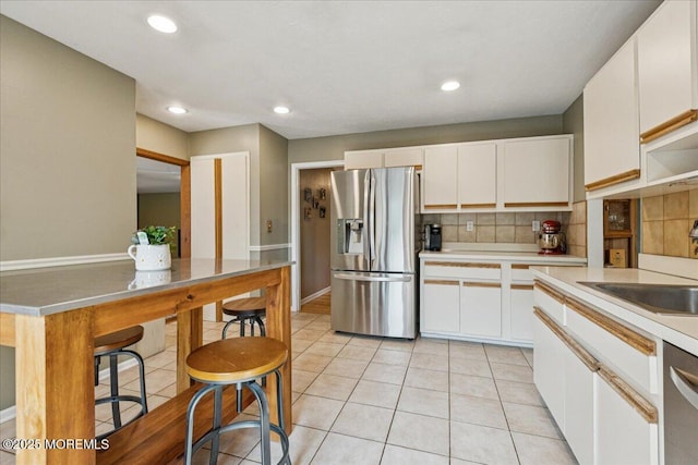 19 Meadowbrook Ln, Freehold, NJ 07728 - kitchen featuring appliances with stainless steel finishes, a sink, light countertops, tasteful backsplash, and white cabinetry