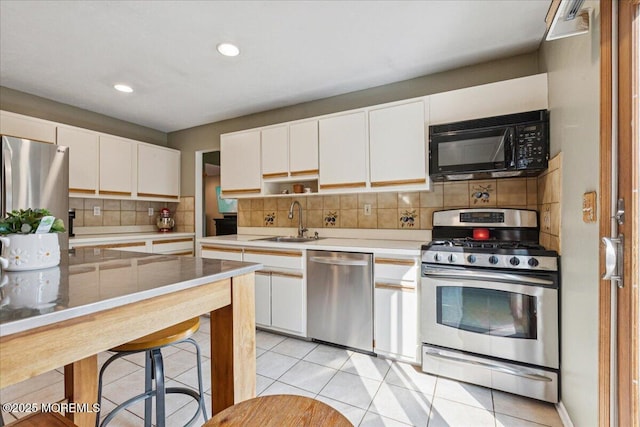 19 Meadowbrook Ln, Freehold, NJ 07728 - kitchen featuring appliances with stainless steel finishes, a sink, tasteful backsplash, white cabinets, and light countertops