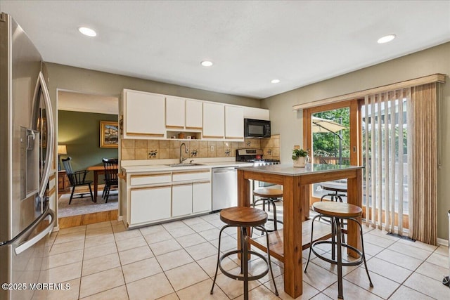 19 Meadowbrook Ln, Freehold, NJ 07728 - kitchen featuring stainless steel appliances, a sink, light countertops, decorative backsplash, and light tile patterned floors