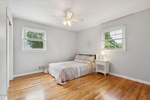 19 Meadowbrook Ln, Freehold, NJ 07728 - bedroom with multiple windows, wood finished floors, and baseboards