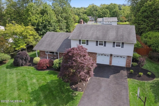 19 Meadowbrook Ln, Freehold, NJ 07728 - view of front of home with driveway, brick siding, a garage, a chimney, and a shingled roof