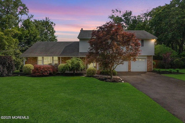 19 Meadowbrook Ln, Freehold, NJ 07728 - view of front of home featuring asphalt driveway, brick siding, an attached garage, and a front yard