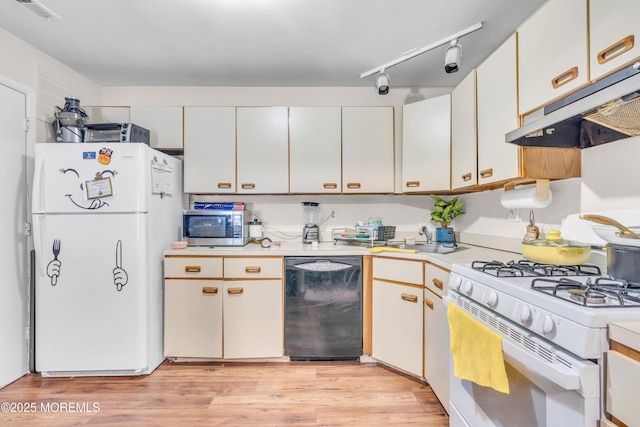 716 Zlotkin Cir Unit 1, Freehold, NJ 07728 - kitchen with white appliances, under cabinet range hood, light countertops, light wood-type flooring, and a sink