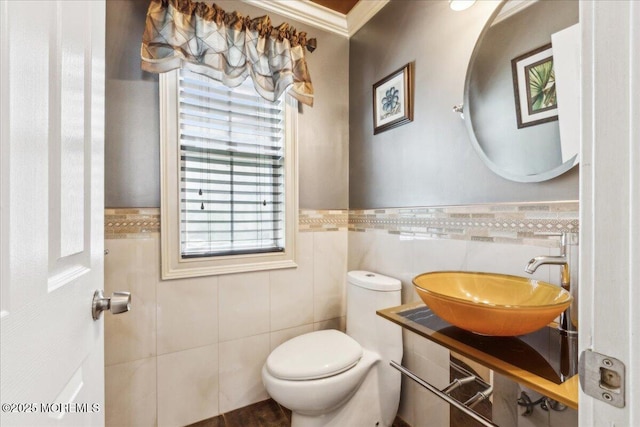 34 Crescent Rd, Old Bridge, NJ 08857 - half bathroom with tile walls, a sink, toilet, ornamental molding, and a wainscoted wall