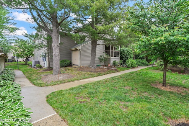 view of home's exterior featuring a lawn and central AC unit