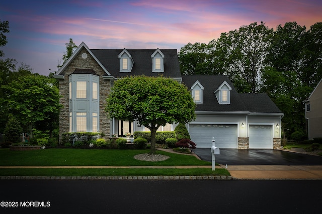 68 Hedgerow Ln, Manalapan, NJ 07726 - view of front of house featuring stone siding, asphalt driveway, a yard, and an attached garage