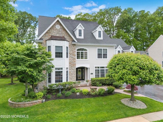 68 Hedgerow Ln, Manalapan, NJ 07726 - view of front facade featuring stone siding, a front yard, and stucco siding