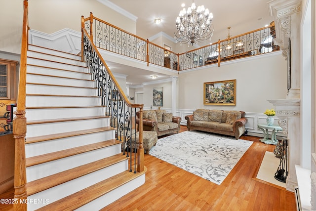 68 Hedgerow Ln, Manalapan, NJ 07726 - living room with a high ceiling, ornamental molding, stairway, wood finished floors, and ornate columns