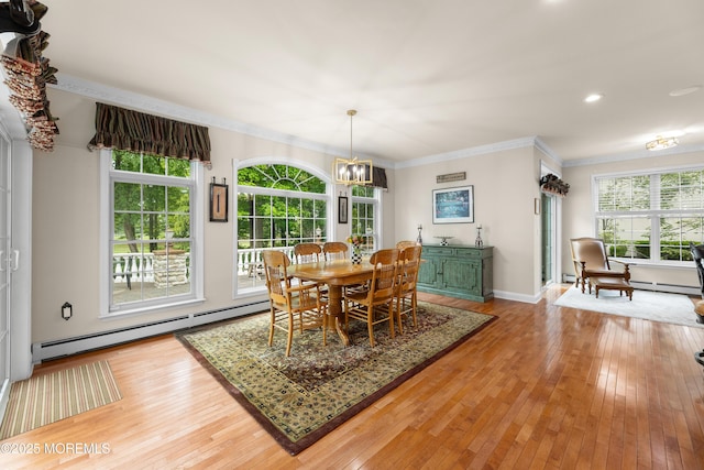 68 Hedgerow Ln, Manalapan, NJ 07726 - dining area with a baseboard heating unit, light wood finished floors, ornamental molding, a chandelier, and baseboard heating