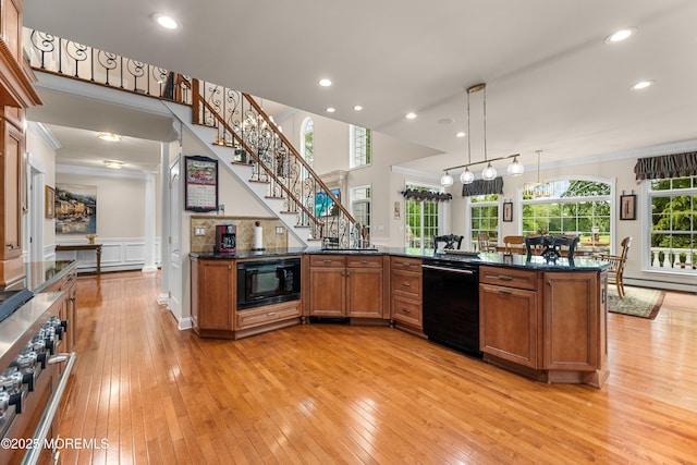 68 Hedgerow Ln, Manalapan, NJ 07726 - kitchen featuring black appliances, brown cabinets, light wood-type flooring, a decorative wall, and plenty of natural light