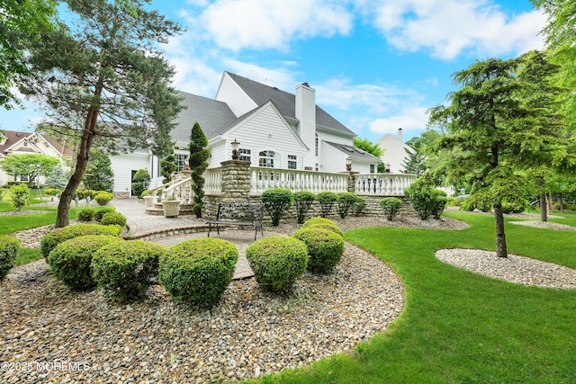 68 Hedgerow Ln, Manalapan, NJ 07726 - back of house with a lawn, a patio, a chimney, and a wooden deck