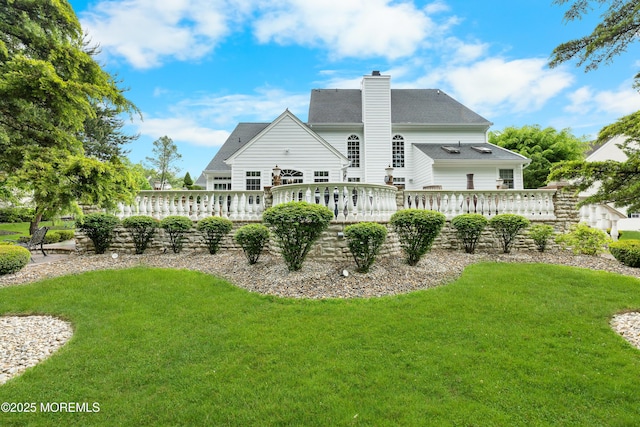 68 Hedgerow Ln, Manalapan, NJ 07726 - back of house with a wooden deck, a lawn, and a chimney