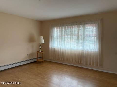 4 Flamingo Way, Toms River, NJ 08757 - spare room featuring healthy amount of natural light, wood finished floors, baseboard heating, and baseboards