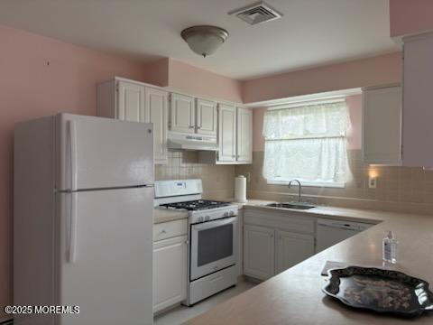 4 Flamingo Way, Toms River, NJ 08757 - kitchen with white appliances, a sink, under cabinet range hood, and backsplash
