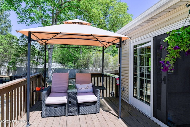 wooden terrace with a gazebo and fence