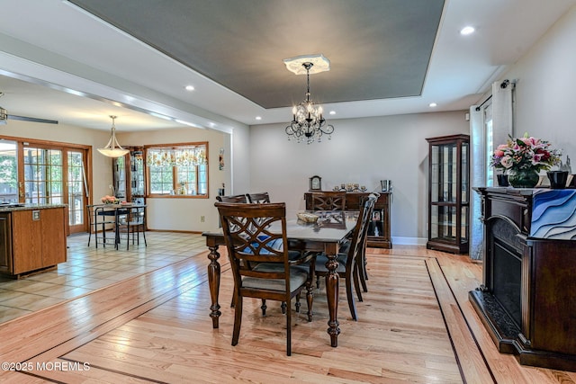 dining area featuring recessed lighting, baseboards, light wood-type flooring, and a chandelier