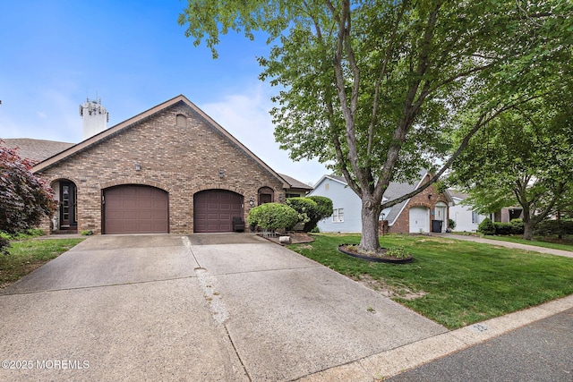 22 Fir Rd Unit 25, Manahawkin, NJ 08050 - view of front of house with brick siding, a front yard, a garage, and concrete driveway