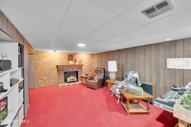 1223 Clover Rd, Brick, NJ 08724 - carpeted living room featuring a drop ceiling, a fireplace, and wooden walls