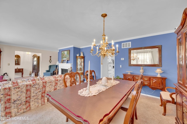 1223 Clover Rd, Brick, NJ 08724 - dining area featuring light carpet, a chandelier, ornamental molding, and a fireplace